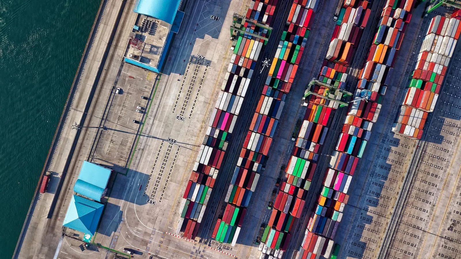 Aerial view of a container lot with trucks and stacked containers