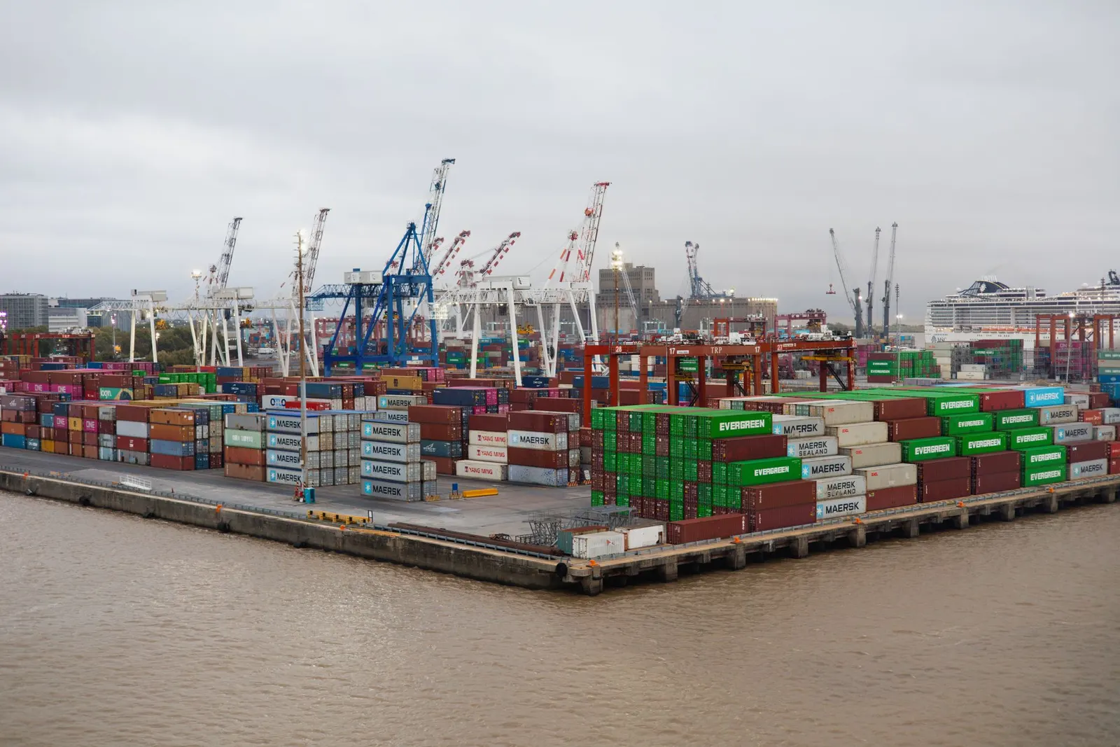 Gantry cranes over stacked 20FT and 40FT shipping containers at a port container terminal