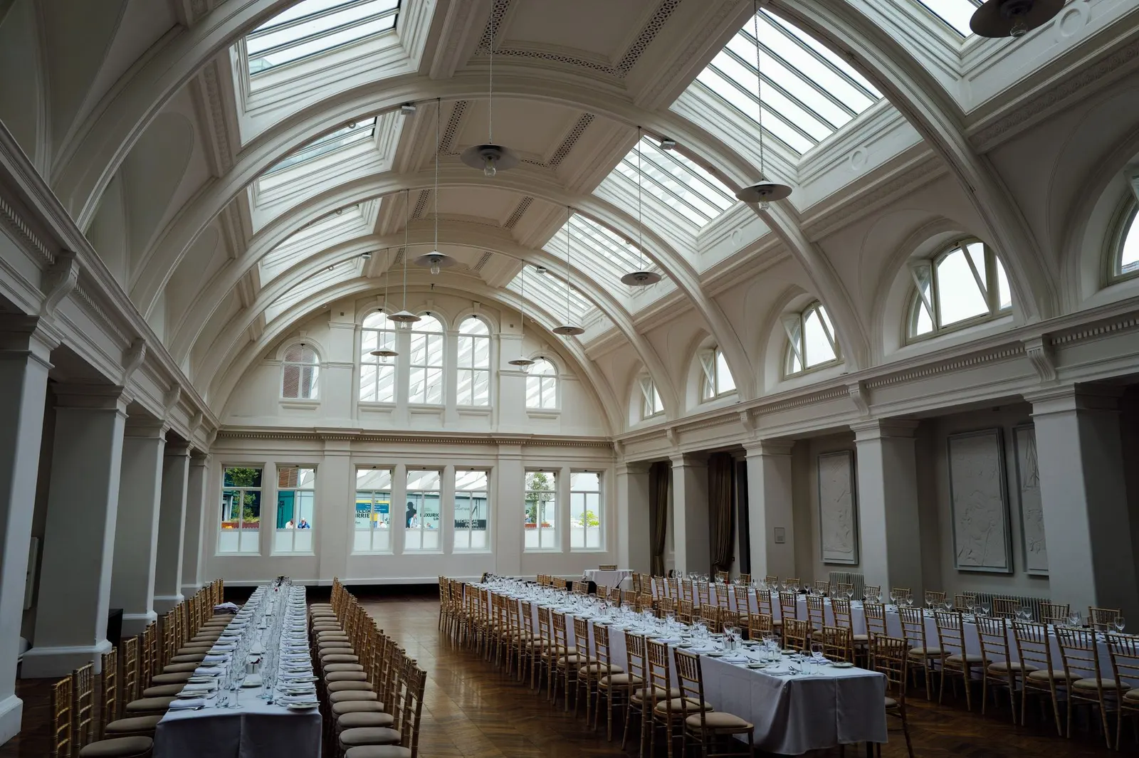 Banquet hall set with long tables for a corporate dinner
