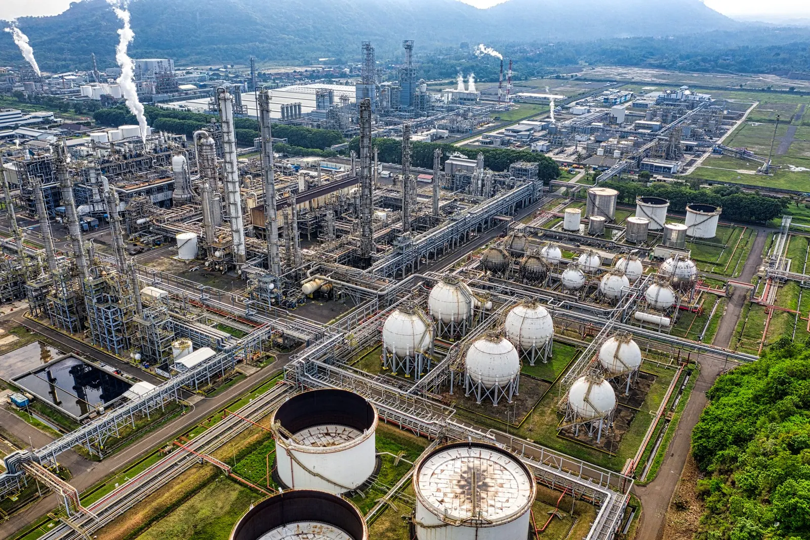 Aerial view of an industrial processing plant with storage tanks